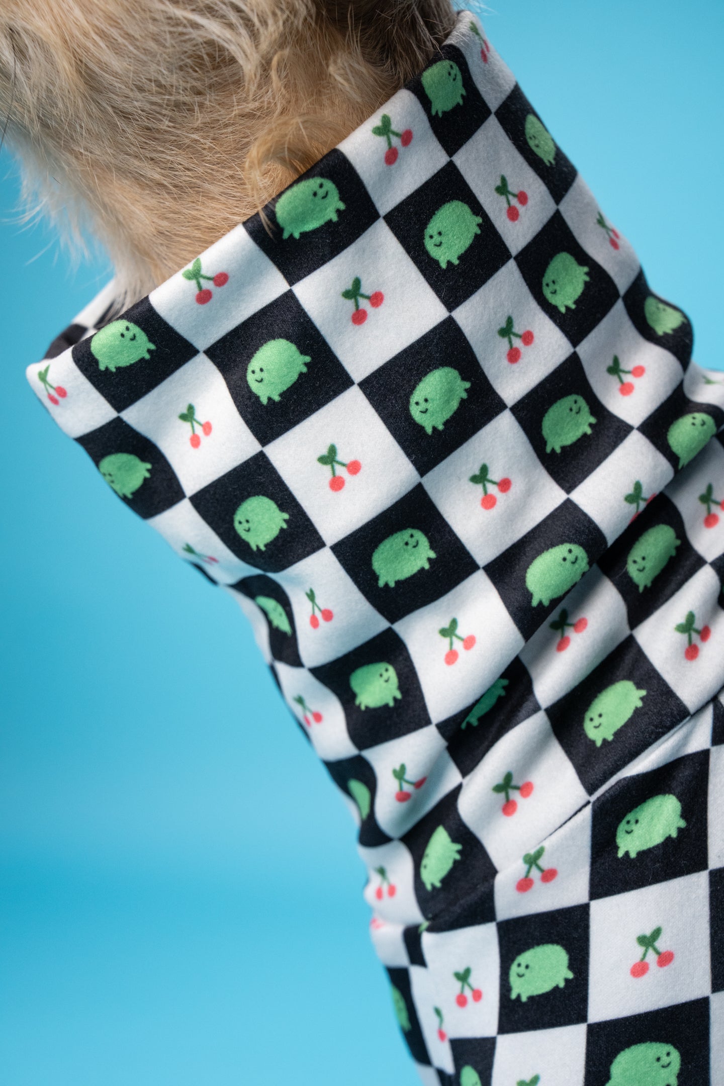 close-up of turtle neck design on sighthound pj's. the pattern has fruit and animal pattern.
